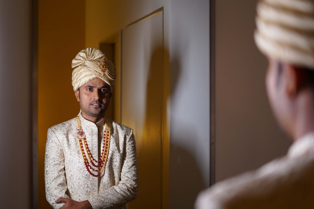 Wedding Photography - Groom looking into the mirror