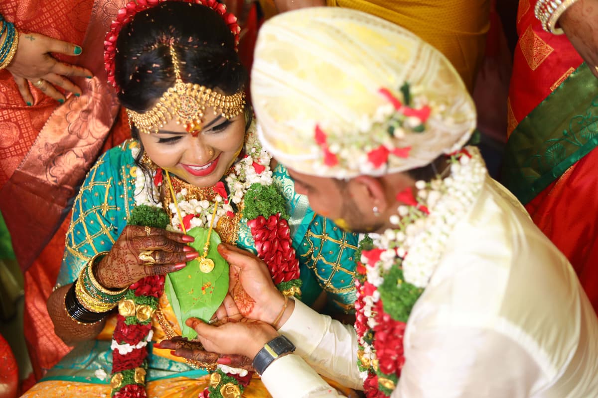 Wedding Photography - Bride and Groom showing brides mangalsutra